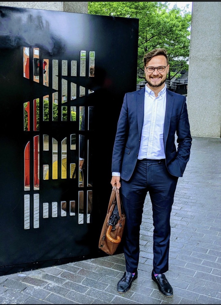Francis in a suit outside the IBM offices in London